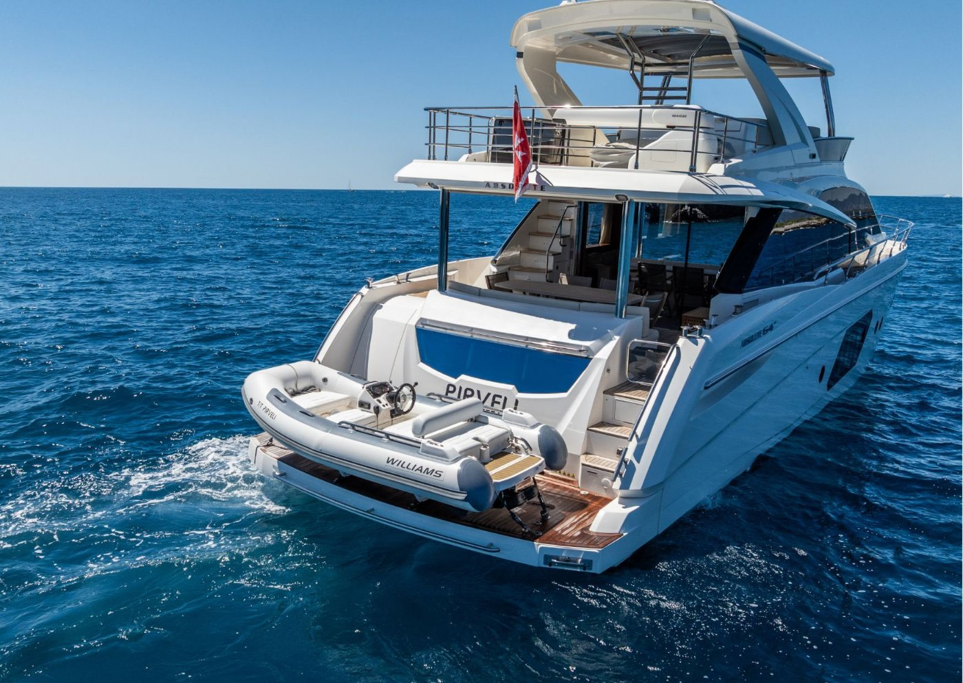 pirveli motor yacht from behind, on blue waters