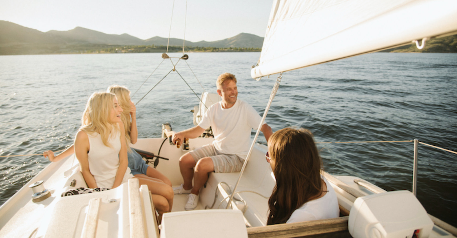 Yacht charter broker scams, group of friends on a yacht.