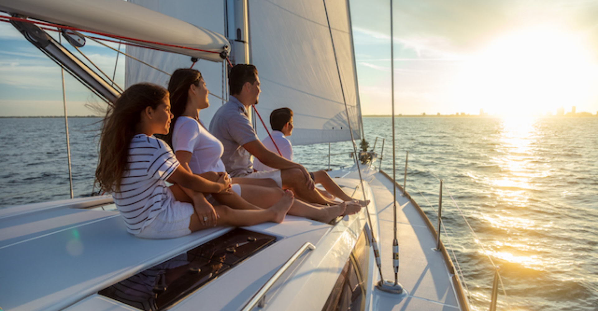 Yacht charter flexibility, a family of 4 enjoying the view on a yacht deck.