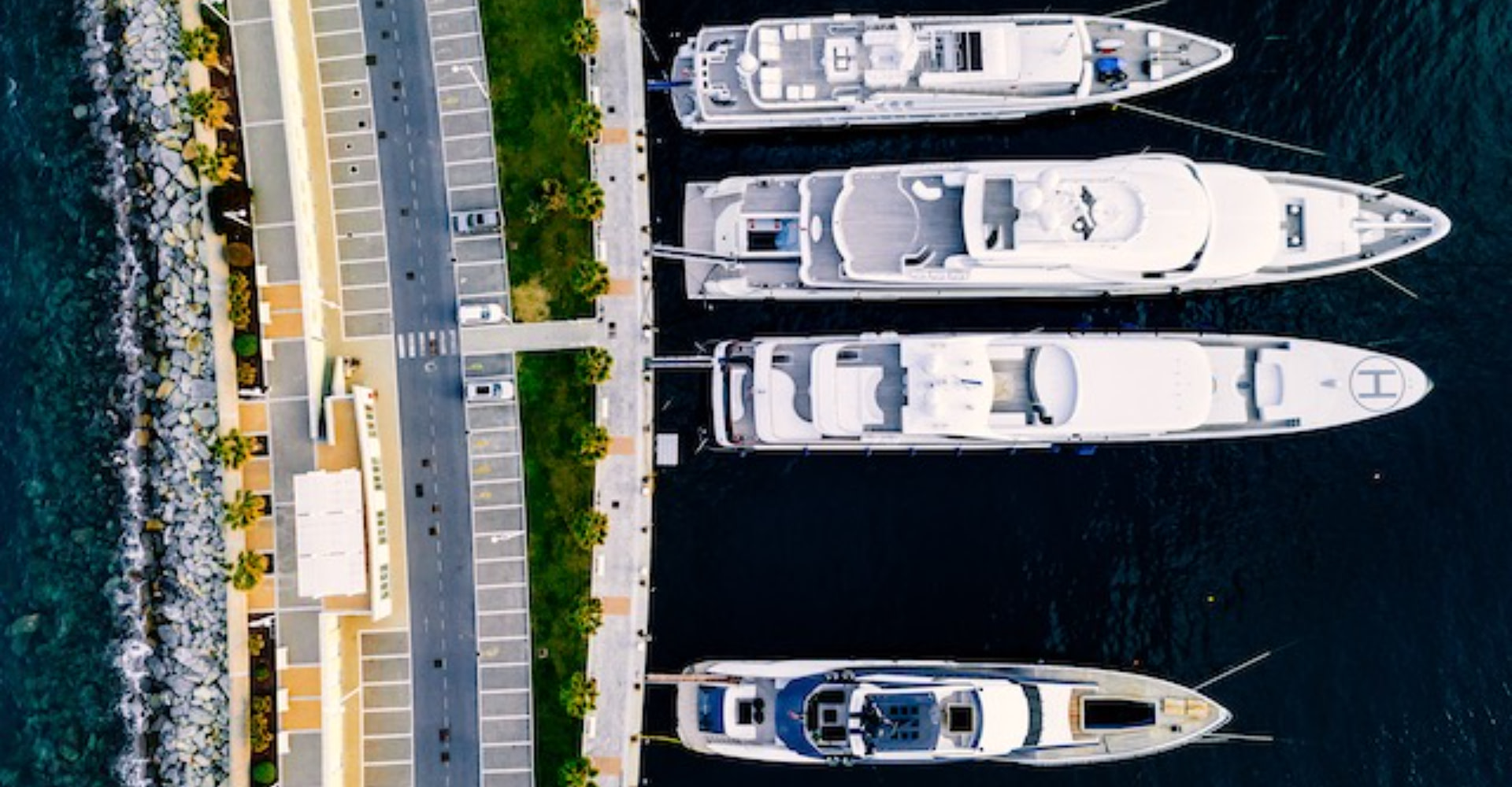 Exclusive yacht brands, large luxury yachts docked.