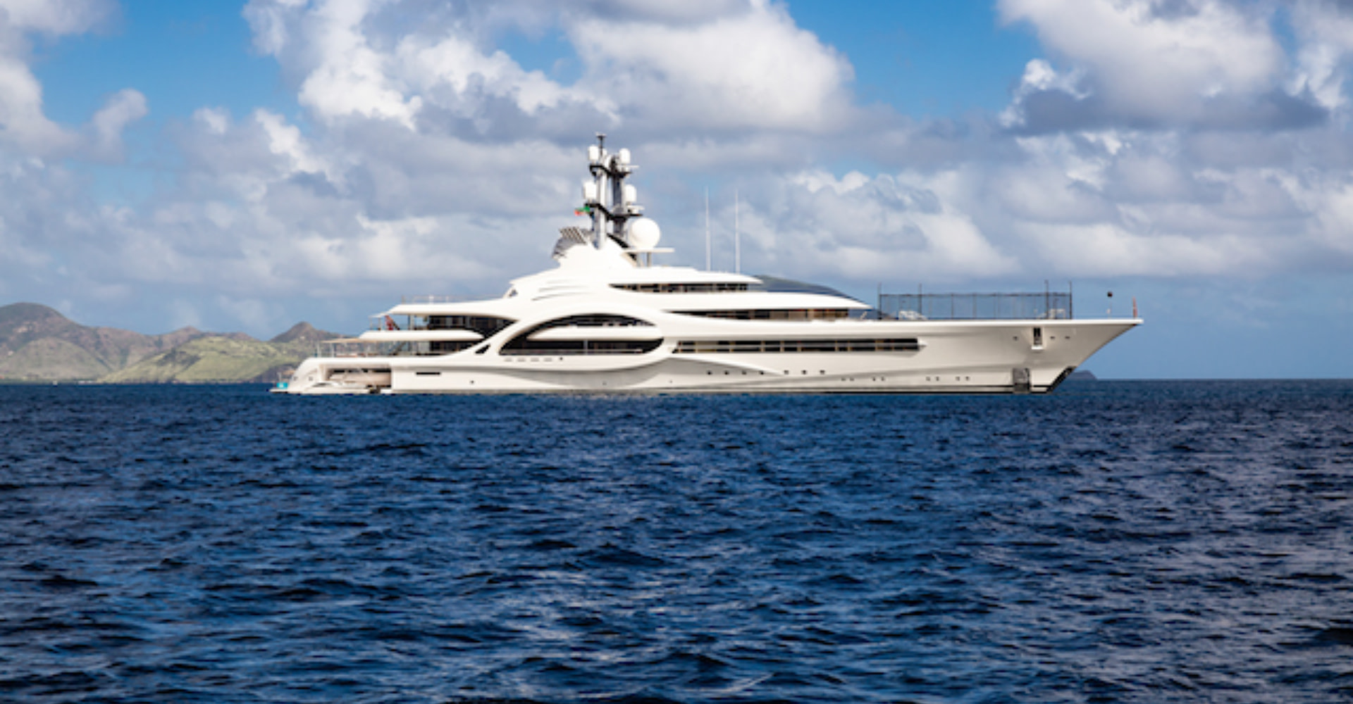 €1 Million Per Week Yacht Charter, white mega yacht at sea.