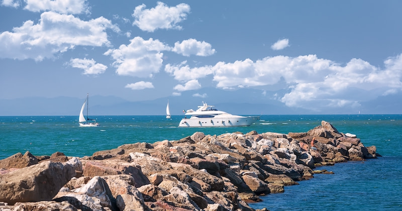 €300000 per week superyacht, a yacht and sailing boats at sea.